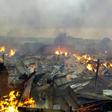 Collapsed stalls burned in the market in Bouake a day after fire broke out in the night