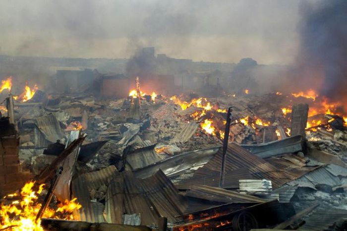 Collapsed stalls burned in the market in Bouake a day after fire broke out in the night
