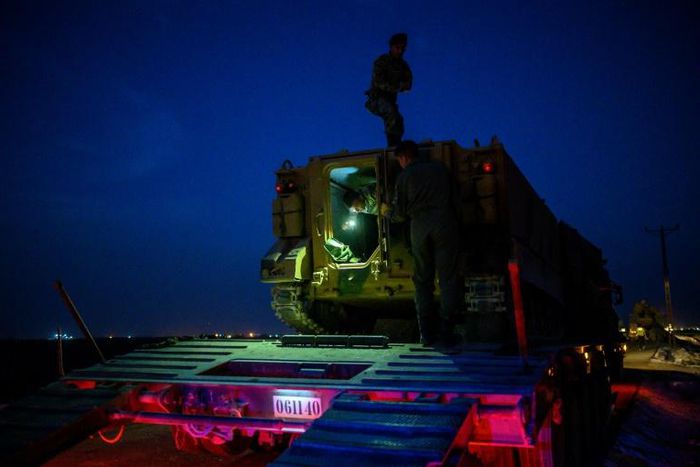 Turkish troops keep up their build-up along the Syrian border though the night as the government promises a long-threatend assault on the Kurdish-ruled northeast will begin "soon"