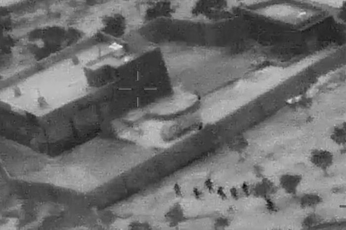 This still image from a video released by the US Department of Defense shows US forces (lower R) advancing on the compound of Islamic State group leader Abu Bakr al-Baghdadi in Syria