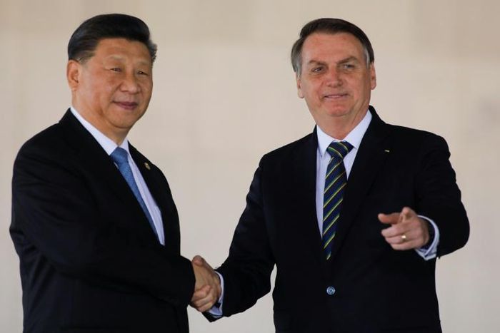 China's President Xi Jinping (L) and Brazil's President Jair Bolsonaro (L) before a summit in Brasilia of the BRICS countries where global trade was on the agenda