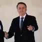 China's President Xi Jinping (L) and Brazil's President Jair Bolsonaro (L) before a summit in Brasilia of the BRICS countries where global trade was on the agenda