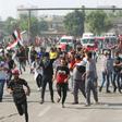 Iraqi security forces use tear gas to disperse the crowds in Baghdad as thousands of protesters massed near the high-security Green Zone in the second phase of a wave of anti-government demos