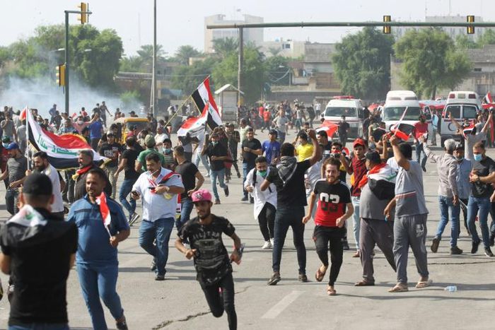 Iraqi security forces use tear gas to disperse the crowds in Baghdad as thousands of protesters massed near the high-security Green Zone in the second phase of a wave of anti-government demos