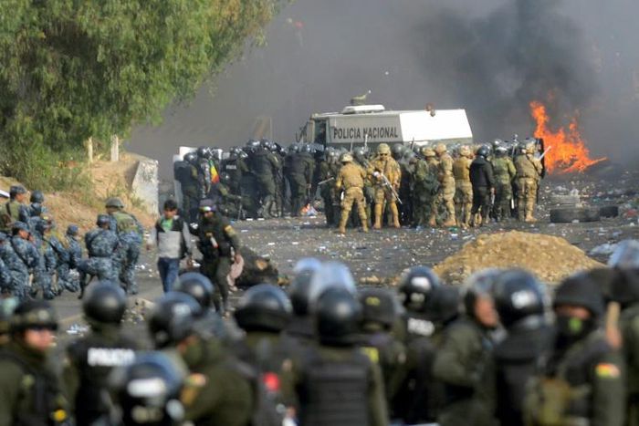 Bolivian riot police and soldiers clash with supporters of ex-President Evo Morales during a protest in the Cochabamba department  on November 15