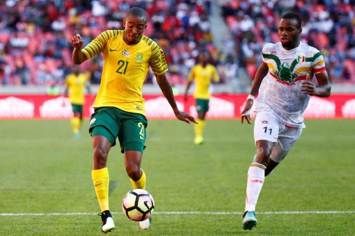 Thapelo Morena (L) of South Africa controls the ball with Lassina Coulibaly of Mali in pursuit