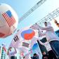 South Korean conservative activists roll a large balloon showing the US flags by a South Korean flag during a rally to support South Korea-US free trade agreement in Seoul in 2012