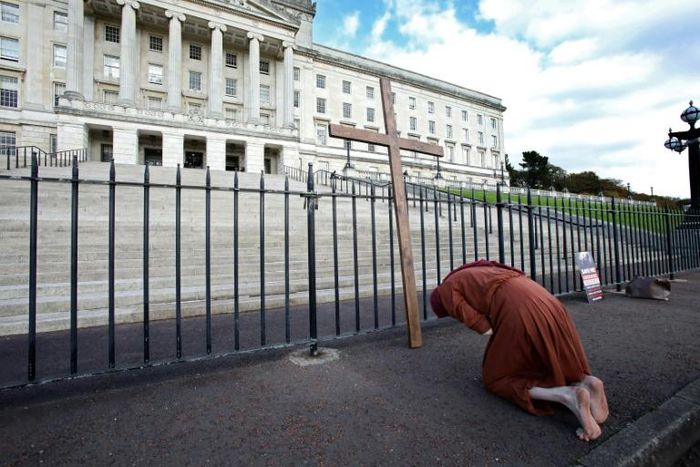 An anti-abortion activist demonstrates outside the pParliament Building in Belfast on Monday