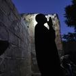 Issa Haidari, who shelters people displaced by violence in Mali, prays after nightfall in the garden at his home in Segou