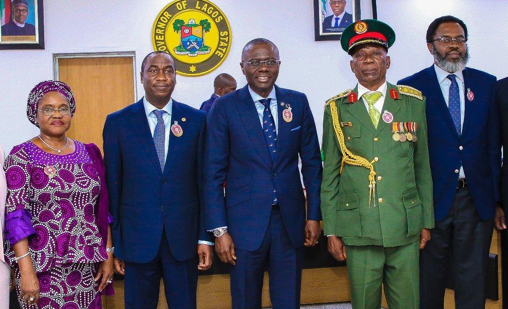 Lagos State Governor, Mr. Babajide Sanwo-Olu (middle) being decorated with the Armed Forces Remembrance Day Emblem by the Chairman, Nigerian Legion, Lagos State Chapter, Col. Samuel Akande (Rtd) (right), while Commissioner for Home Affairs, Mrs Uzamat ...