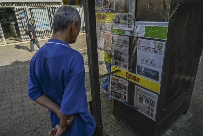 A man looks at the front pages of newspaper in Medellin, Colombia after FARC leaders announced a return to arms