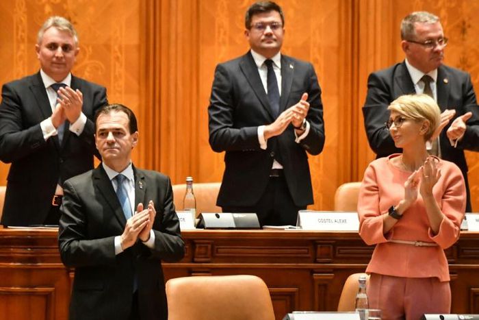 Romanian Prime Minister Ludovic Orban is applauded by members of his cabinet after a vote for a new government at the Romanian Parliament in Bucharest on November 4, 2019
