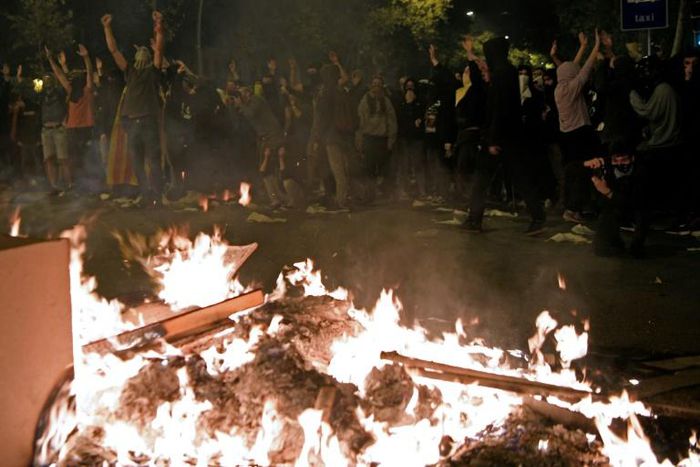 Protesters set fire to barricades during a protest in Barcelona on October 16