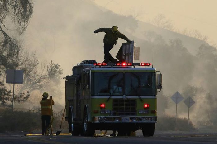 Firefighters work during the Tick Fire on October 24, 2019 in Canyon Country, California.