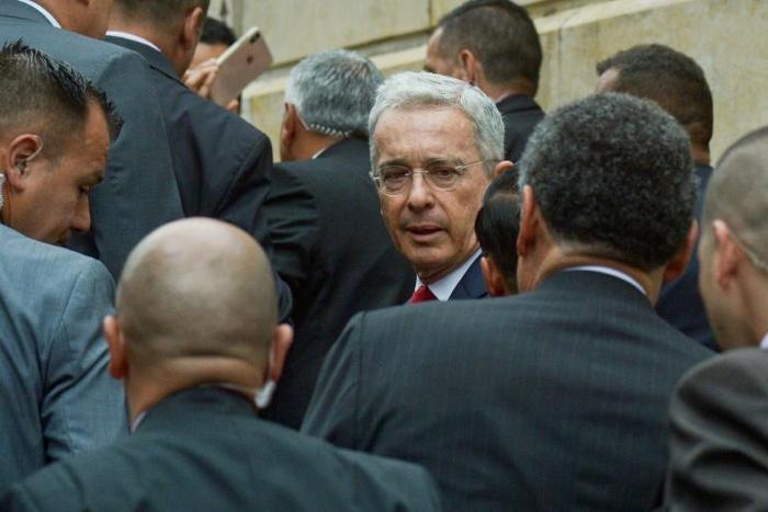 Former Colombian president Alvaro Uribe (C) arrives at the Palace of Justice for a hearing before the Supreme Court in a case over witness tampering