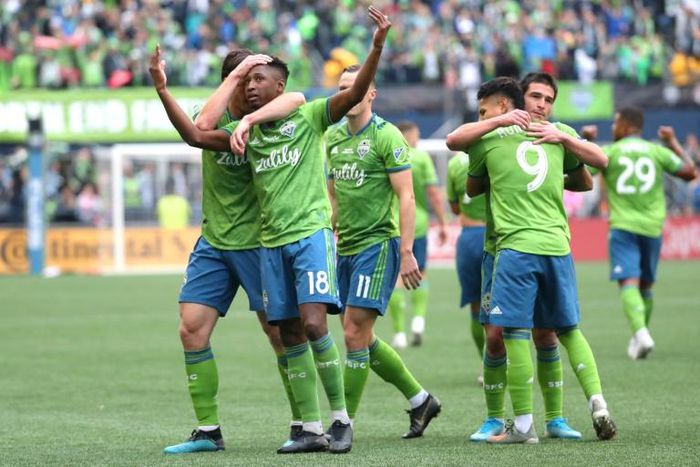 Seattle's Kelvin Leerdam, with arms raised, celebrates with teammates after putting the Sounders ahead on their way to a 3-1 victory over Toronto FC in the MLS Cup final on Sunday