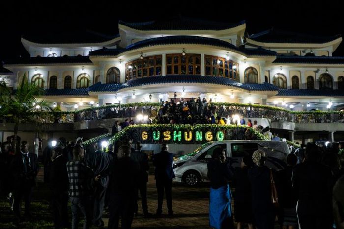 Mourners gather for a funeral wake as the casket of late Zimbabwean President Robert Mugabe arrives at his former Blue Roof residence in Harare
