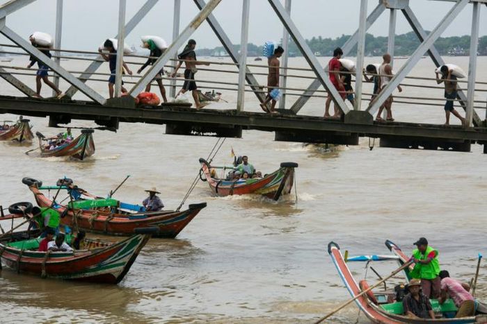 People from Dala township arrive in Yangon by boat after crossing the river