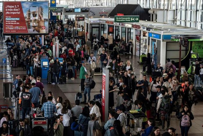 Thousands have been stranded at Santiago's international airport with flights cancelled and delayed because of unrest in the city
