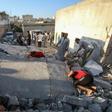 Syrian civilians search for survivors under the rubble of a building following a reported airstrike by Syrian regime forces in Maar Shurin on the outskirts of Maaret al-Numan in northwest Syria's Idlib province
