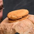 Casey Dean inspects a McDonald's burger he bought in 1995 with friend Eduards Nits and kept in an Australian shed for years