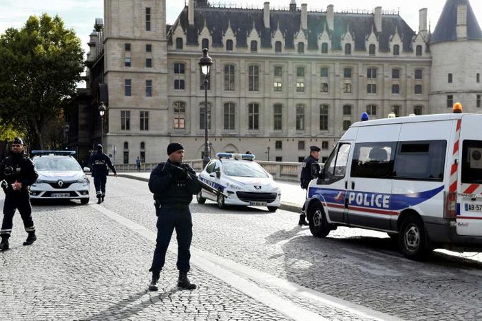 Officers on guard Thursday outside the Paris police headquarters, where an employee stabbed and killed four colleagues before being shot dead.