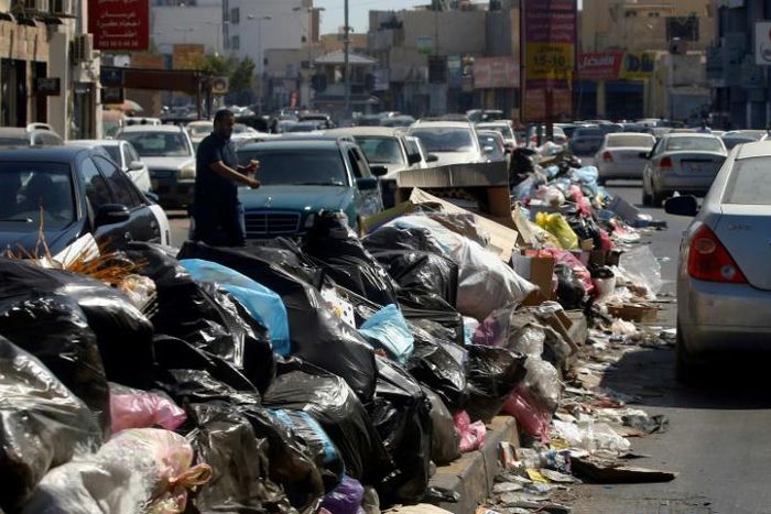 Across Libya's capitol Tripoli, tonnes of waste overflows from bins and piles up on roadsides