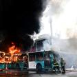 Chilean firefighters extinguish burning buses during clashes between protesters and the riot police in Santiago, on October 19, 2019.Chile's president declared a state of emergency in Santiago Friday night and gave the military responsibility for secur...