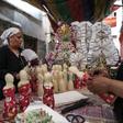 Egyptian women decorate traditional sugar statuettes in the capital Cairo for Al Mawlid Al Nabawi celebrations