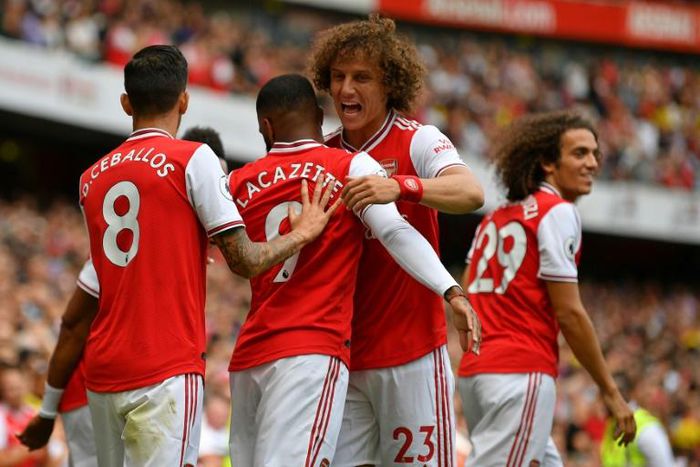 Arsenal defender David Luiz congratulates Alexandre Lacazette