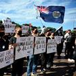 Supporters of the Hong Kong pro-democracy protesters hold placards during a demonstration as part of the global "anti-totalitarianism" movement in Sydney