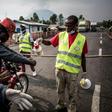 A motor taxi driver gets his hands washed at an Ebola screening station in eastern DR Congo