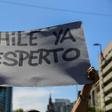 A demonstrator in Santiago holds a sign reading "Chile has awakened"