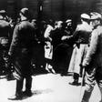 SS soldiers lead newly arrived prisoners to the gas chambers at the Auschwitz concentration camp. The death camp remains an enduring symbol of the Holocaust.