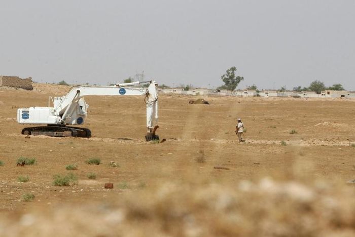 Iraqi mine clearers working for Halo Trust, a non-profit organization specialized in mine removal, scan an agricultural area near Iraq’s Baiji, an oil-rich region ravaged by fighting against the Islamic State group in 2014