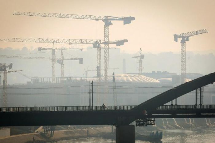A man rides a bicycle on one of Belgrade's bridges on October 27, 2019. Serbian health authorities warned on October 27, 2019, against "very high" air pollution in Belgrade and several other cities in the country, a situation that has persisted for sev...