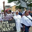 Protestors held up placards reading 'Children shot, Future lost,' and 'Alpha, stop killing our children'