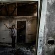 Magalie Noel Dresse, owner of the Caribbean Craft factory, walks through the remains of the factory in Port-au-Prince