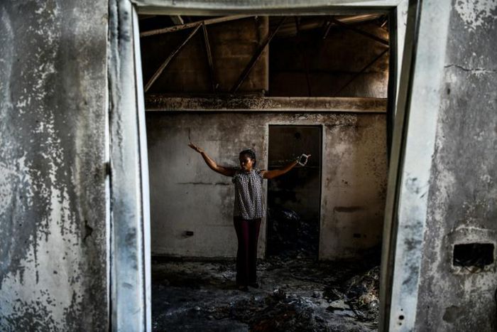 Magalie Noel Dresse, owner of the Caribbean Craft factory, walks through the remains of the factory in Port-au-Prince