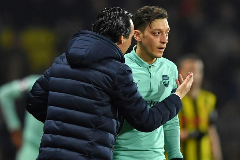 Mesut Ozil (right) is frustrated at his lack of game time under Arsenal manager Unai Emery