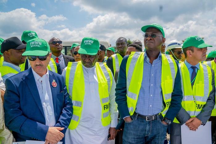 Minister of Works and Housing, Babatunde Raji Fashola on project inspection with contractors.