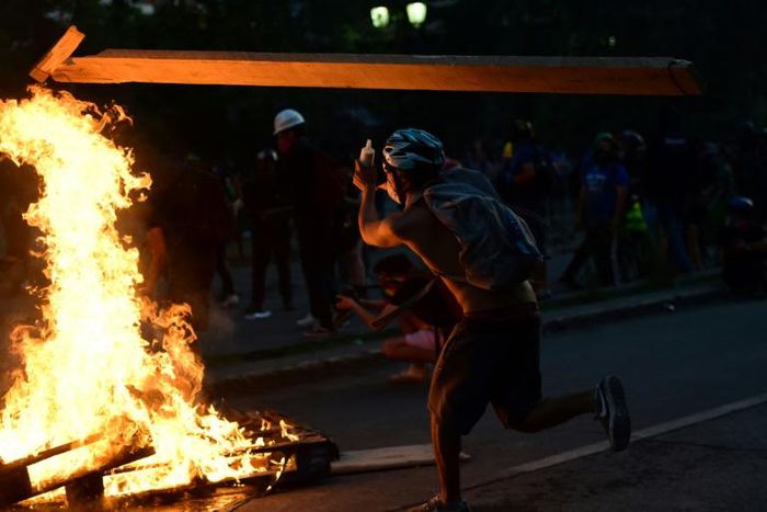 A demonstrator takes part in a protest against the government in Santiago, Chile on November 14, 2019