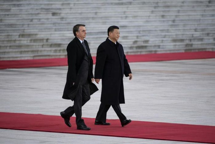 President Jair Bolsonaro (L) will walk a diplomatic tightrope as he hosts his Chinese counterpart Xi Jinping (R) in Brazil