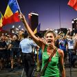 An estimated 24,000 protesters gathered in front of the government's headquarters in Bucharest, waving the national flag and shouting  "Thieves!"