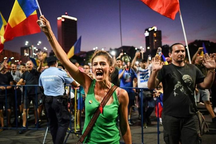 An estimated 24,000 protesters gathered in front of the government's headquarters in Bucharest, waving the national flag and shouting  "Thieves!"