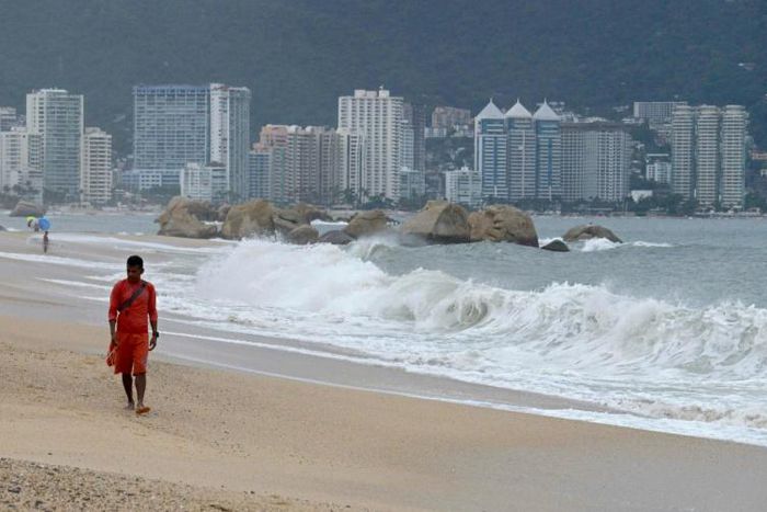 A lifeguard walks along the beach in Acapulco, Mexico on September 18, ahead of Lorena's expected arrival