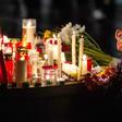 People leave candles and flowers at a vigil at the Marktplatz in Halle, eastern Germany
