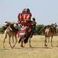 Sudanese villagers carry belongings on camels in the Darfur village of Shattaya following their return home last year after more than a decade of being displaced by war
