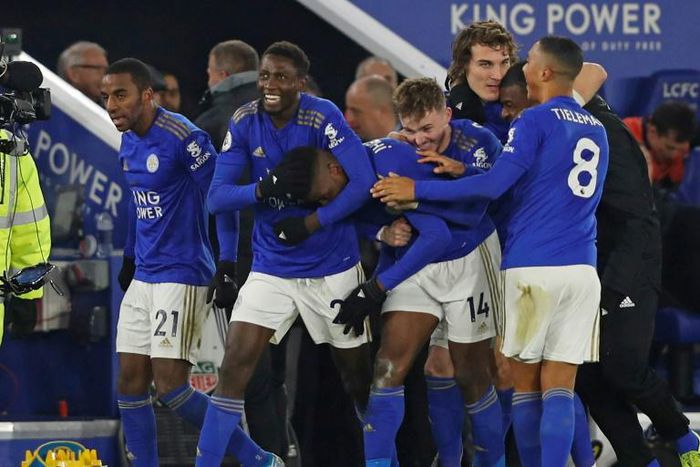 Super sub: Kelechi Iheanacho (centre) is mobbed by his teammates after a late winner against Everton