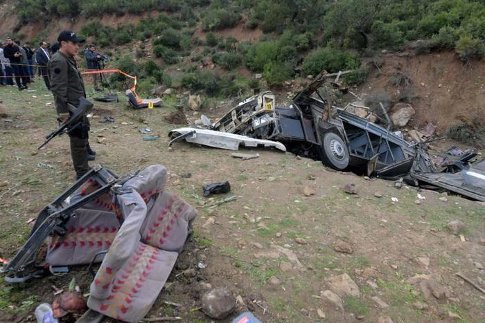 Tunisian security forces check the remains of a bus that plunged over a cliff into a ravine, in Ain Snoussi in northern Tunisia on December 1, 2019 killing 24 people